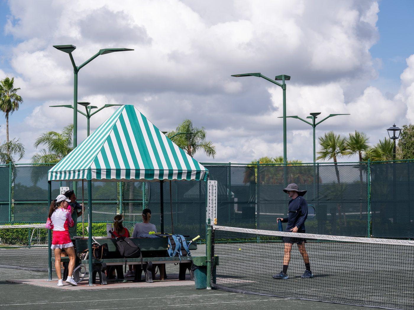 Heritage Oaks Har-Tru clay tennis courts with shaded cabana